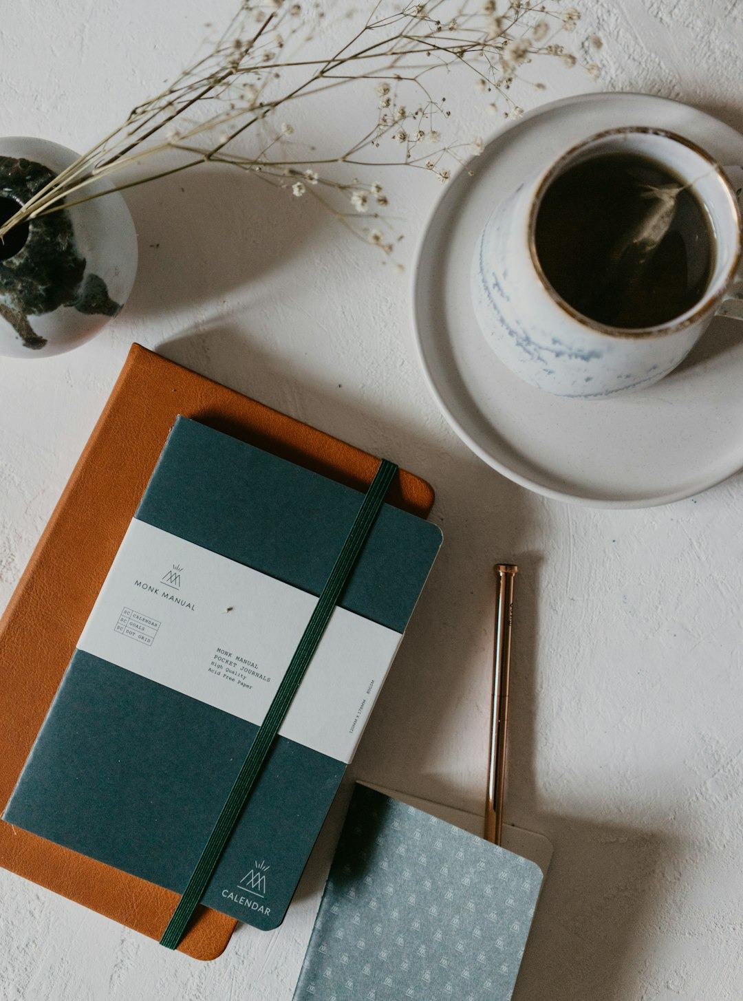 Stationery items for planning and journaling laid out on a table.